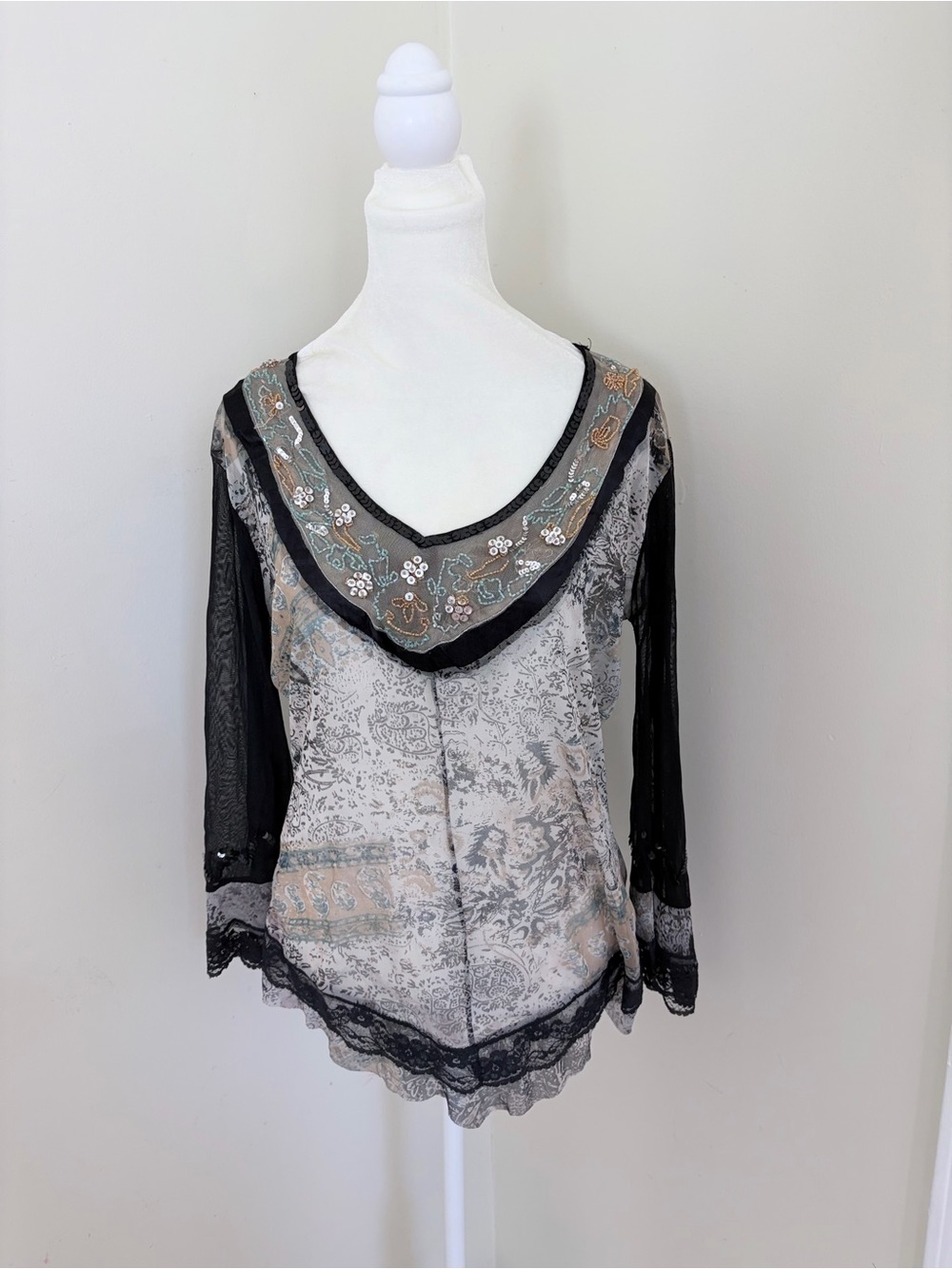 Vintage long sleeve top features a grey and black paisley print with intricate b